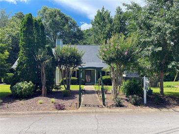 Charming home with a beautifully landscaped front yard and inviting walkway at 728 Slew Ave, Lawrenceville, GA 30043