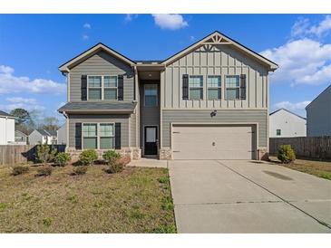 Charming two-story home with a well-maintained lawn and a two-car garage at 3038 Chris Cir, Villa Rica, GA 30180