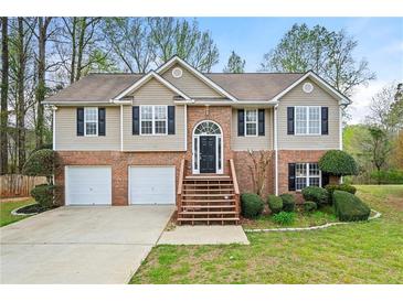 Charming two-story home with brick accents, a two-car garage, and manicured landscaping at 1160 Chateau Ter, Mcdonough, GA 30253