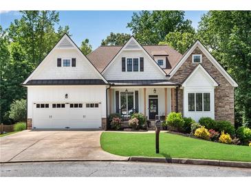 Charming home featuring a stone and white siding facade, complemented by a well-manicured lawn and inviting curb appeal at 244 Cedar Ridge Way, Dallas, GA 30157