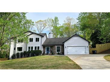 Charming two-story home with landscaped yard and stone accents, perfect curb appeal at 1960 Calvin Dr, Duluth, GA 30097
