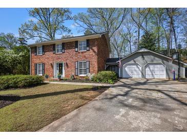 Beautiful brick two-story home with a two-car garage and basketball hoop at 7130 Spalding Ne Ct, Atlanta, GA 30328