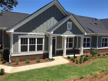 Charming single-story home with gray siding, white trim, and a well-manicured lawn and landscape at 1702 Bonica Xing # 1702, Cumming, GA 30040