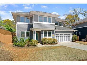 Charming two-story home with gray siding, white trim, well-manicured landscaping, and a two-car garage at 1903 River Birch Ln, Atlanta, GA 30316