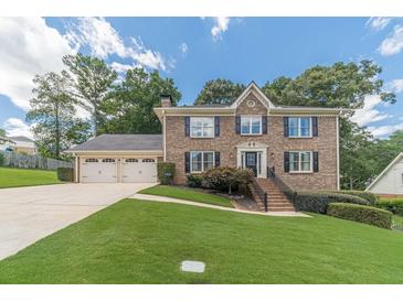 Charming brick home with well-maintained landscaping and a three-car garage at 4481 Lucerne Sw Pl, Lilburn, GA 30047