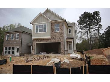 Charming two-story home with brick and beige siding and an attached two car garage in a new neighborhood at 1974 William Glen St, Dacula, GA 30019