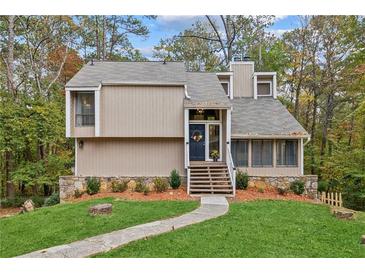 Charming two-story home featuring a landscaped front yard and inviting entrance at 1720 Little Willeo Rd, Marietta, GA 30068