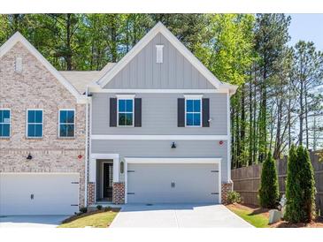 Charming two-story home with a gray exterior, attached garage, and well-maintained landscaping at 1600 Ruskin Way, Marietta, GA 30062