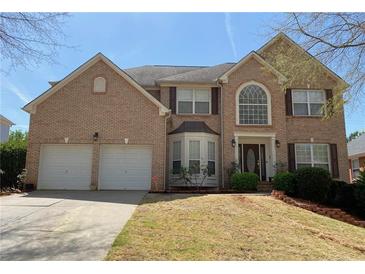 Charming two-story brick home with a well-manicured lawn, attached two car garage, and inviting front entrance at 2688 Autumn Ridge Ln, Lawrenceville, GA 30044