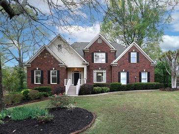 Charming brick home featuring manicured lawn and stylish front entrance at 1514 Haven Crest Dr, Powder Springs, GA 30127