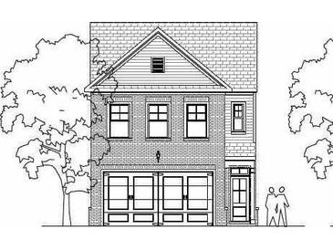 Charming two-story brick home with a two-car garage and classic architectural details, flanked by mature trees at 1914 William Glen St, Dacula, GA 30019