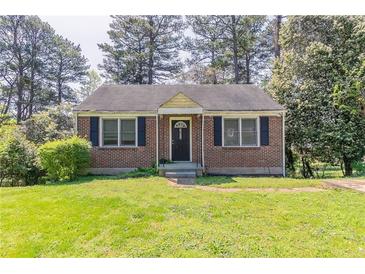 Charming brick home with a well-maintained lawn and traditional landscaping at 1951 Brannen Se Rd, Atlanta, GA 30316