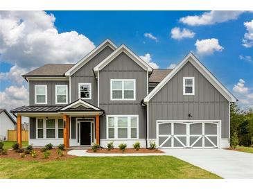 Beautiful two-story home with gray siding, white trim, and a well-manicured lawn at 8245 Dawson View Way, Cumming, GA 30028