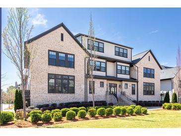 Beautiful multi-level brick home featuring manicured landscaping and black trim at 3905 Danube Ln # 215, Atlanta, GA 30339