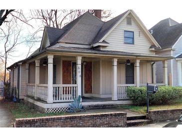 Charming home featuring a front porch with columns and a brick foundation at 698 Ira St, Atlanta, GA 30310