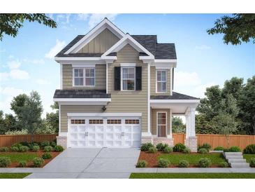 Charming two-story home featuring a two-car garage and welcoming front porch at 354 Friendship Oak Way, Hampton, GA 30228