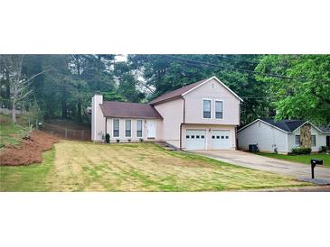 Charming two-story home with a well-maintained lawn and a convenient two-car garage at 849 Cadet Nw Ct, Lilburn, GA 30047