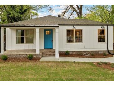 Charming white home with a bright blue front door and inviting front porch at 244 Birch St, Atlanta, GA 30354