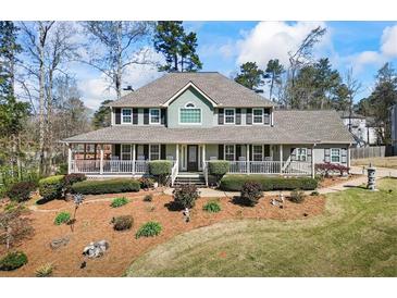 Charming home features a wide porch, manicured landscaping and a classic, welcoming facade at 9549 Clear Lake Court, Douglasville, GA 30135