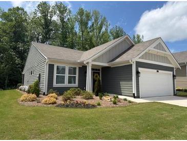 Charming single-story home features manicured lawn and a two-car garage at 63 Aspen Way, Dallas, GA 30157