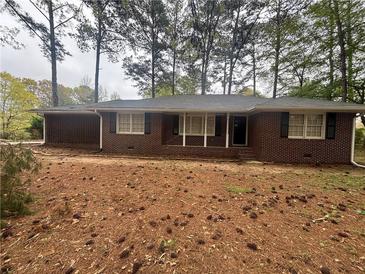 Charming brick home with a classic design and a cozy front porch at 3488 Richmond Se Dr, Conyers, GA 30094