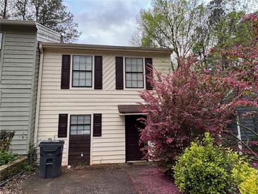 Charming two-story townhouse with neutral siding, dark shutters, and a well-maintained front yard at 3839 Henry Ct, Acworth, GA 30101