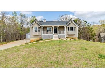 Charming home featuring a welcoming front porch and well-maintained lawn at 167 Fairview Oak Trl, Dallas, GA 30157