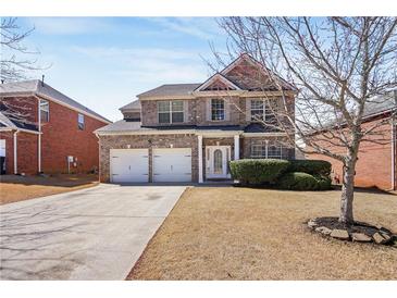 Charming two-story brick home with a two-car garage and well-maintained front yard in a suburban neighborhood at 3642 Sunbridge Dr, Snellville, GA 30039