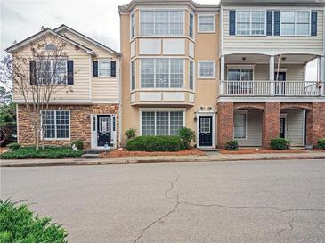 Street view of well-maintained townhomes showcasing varied architectural styles and manicured landscaping at 111 Riverstone Commons Cir, Canton, GA 30114