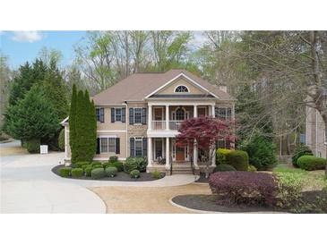Charming two-story home with a welcoming front porch and manicured landscaping at 4981 Millwood Dr, Canton, GA 30114