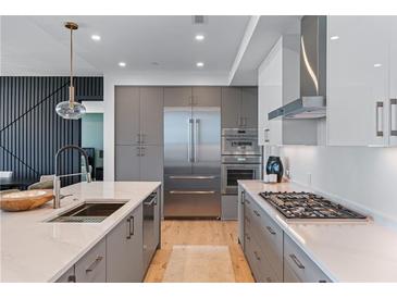 Modern kitchen with stainless appliances, gray cabinets and quartz counters at 2425 Peachtree Ne Rd # 1211, Atlanta, GA 30305