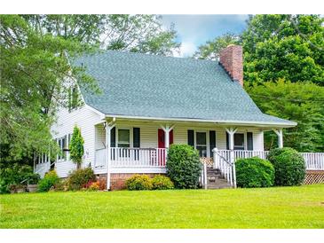 Charming home features a quaint porch and landscaped front yard at 3545 Liberty Rd, Villa Rica, GA 30180