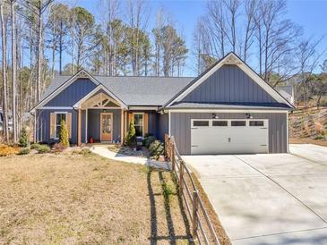 Charming single-story home featuring a two-car garage, inviting entrance, and manicured lawn at 1847 Davis Mill Rd, Dallas, GA 30157