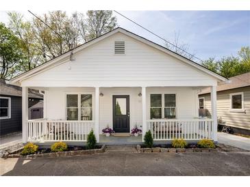 Charming home featuring a welcoming front porch, black front door, and beautifully landscaped front yard at 91 Chester Se Aly, Atlanta, GA 30316