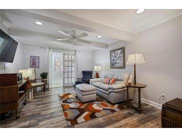 Inviting living room features a comfortable white sofa, ceiling fan, and stylish decor, perfect for relaxation at 138 Elysian Nw Way, Atlanta, GA 30327