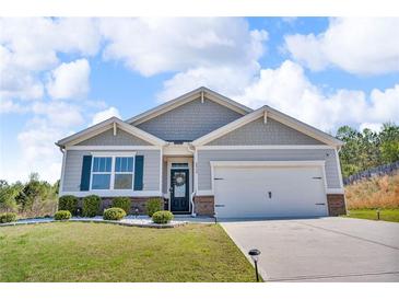 Charming single-Gathering home featuring a two-car garage, and a well-manicured front yard at 6920 Oak Valley Dr, Douglasville, GA 30134