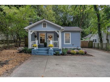 Charming blue home with a cozy front porch and beautifully landscaped front yard at 1812 Defoor Nw Ave, Atlanta, GA 30318