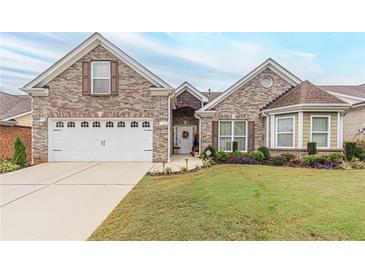 Charming brick home with a well-manicured lawn and a two-car garage, offering curb appeal at 1152 Simonton Glen Way, Lawrenceville, GA 30045