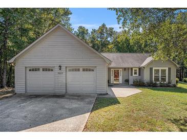Charming single-story home with a two-car garage and well-maintained lawn at 5623 Yeager Dr, Douglasville, GA 30135
