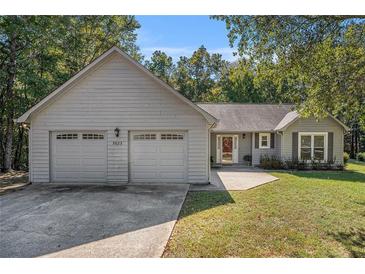 Charming single-story home with a two-car garage and well-maintained front yard at 5623 Yeager Ridge Dr, Douglasville, GA 30135