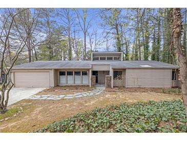 Charming one-story home with a stone walkway, manicured lawn, and a two-car garage at 2243 Provence Ne Ct, Marietta, GA 30066