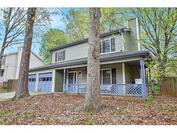 Charming two-story home featuring a covered front porch and a two-car garage at 835 Ridge Ave, Stone Mountain, GA 30083