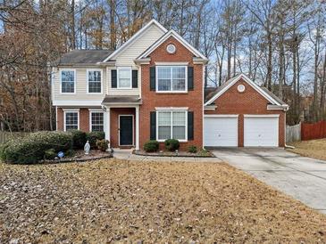 Charming two-story home featuring brick accents, a two-car garage, and a well-maintained front yard at 184 Chamberlyn Ln, Hiram, GA 30141