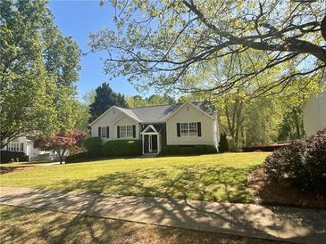 Charming one-story home with a lush green lawn, lovely landscaping, and inviting front entrance at 262 Bomar Ln, Douglasville, GA 30134
