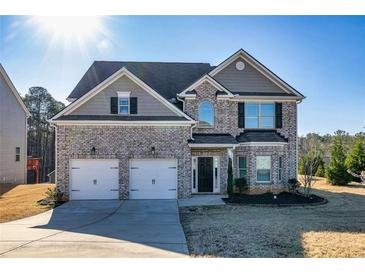Charming brick home with a well-manicured lawn, two car garage, and a welcoming entrance at 3835 Rifflepool Ct, Douglasville, GA 30135