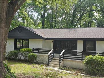 Charming single story home with landscaped front yard and inviting front porch at 1956 Shirley Sw St, Atlanta, GA 30311
