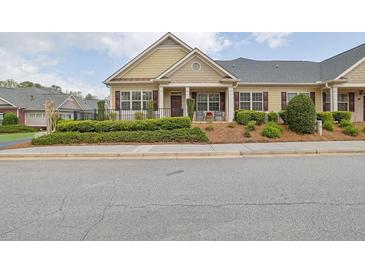 Charming single story home with manicured lawn and inviting front porch at 241 Orchards Cir, Woodstock, GA 30188