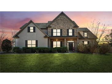 Charming brick and shingle home with a well-manicured lawn and inviting front porch at 5705 Windjammer Pt, Cumming, GA 30041