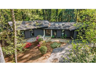 Charming one story home with stone accents, black trim, mature trees, and colorful landscaping at 2568 Sugarplum Ne Ct, Atlanta, GA 30345