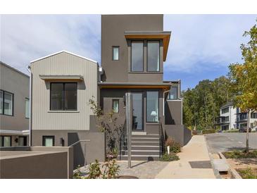 Modern home featuring a two-story facade with a sleek staircase leading to the entrance at 10940 Serenbe Ln, Chattahoochee Hills, GA 30268